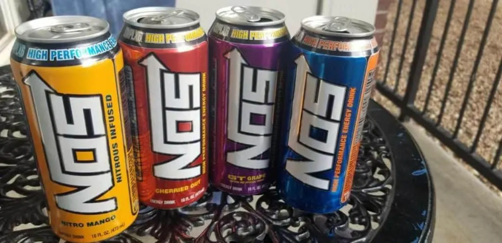 Four cans of NOS energy drinks in different flavors.
