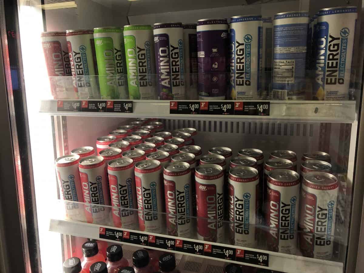 Different flavors of Amino Energy drink in refrigerated shelves.