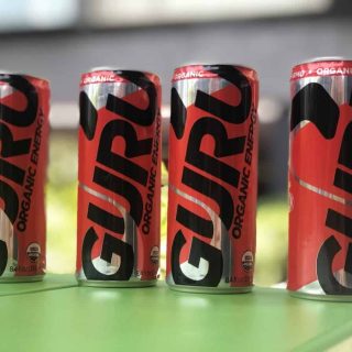 Four cans of Guru Organic Energy Drink