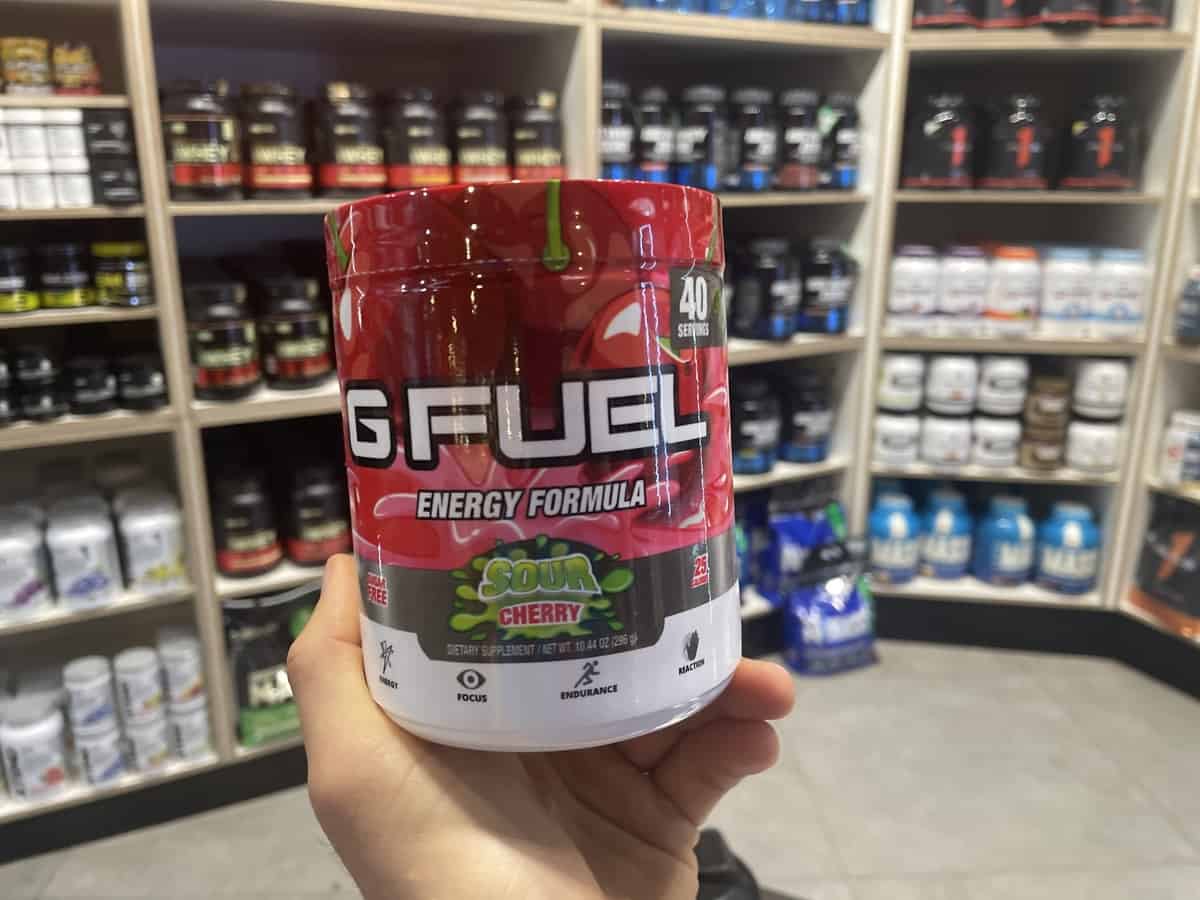 G Fuel Sour Cherry energy tub held in hand