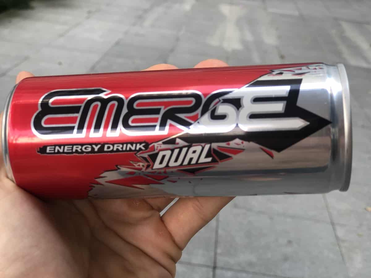 A photo of emerge energy drink dual flavor in a person's hand.
