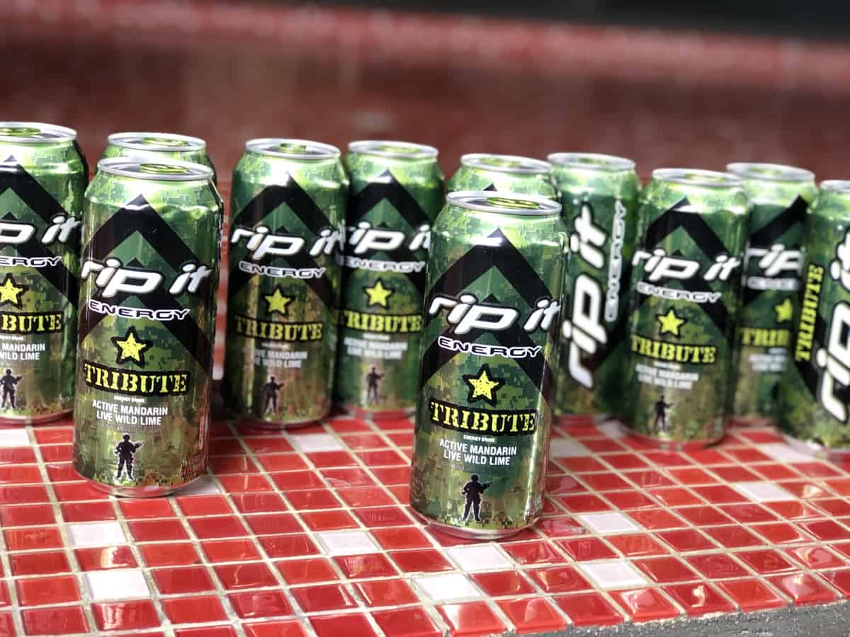 A photo of multiple Rip It energy drinks in a red table in tribute flavor.