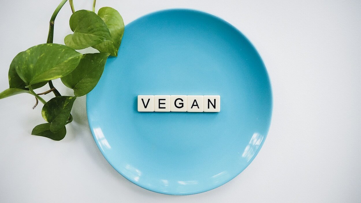 A plate with letters that's spelled out vegan.