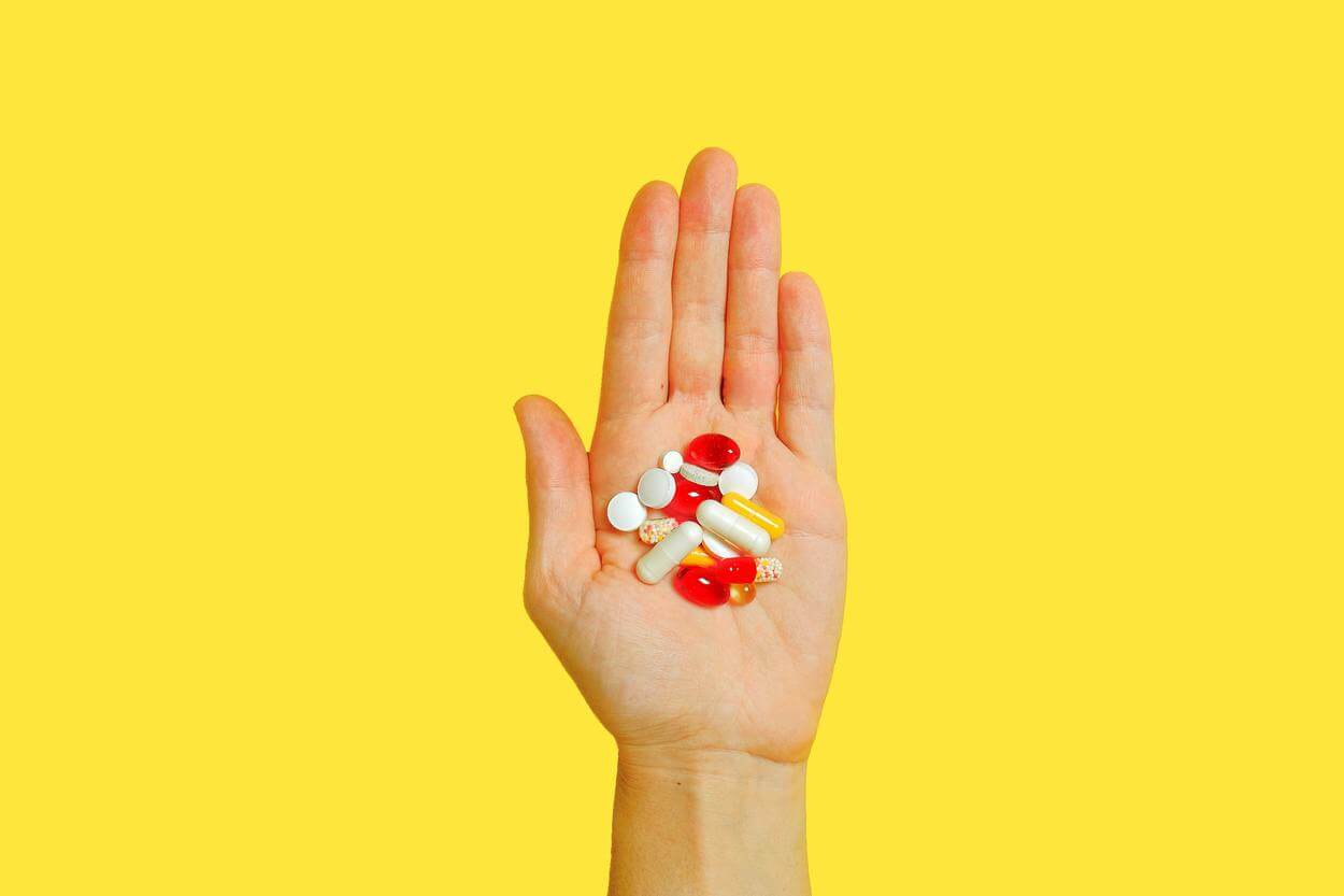 Vitamin pills on a person's palm