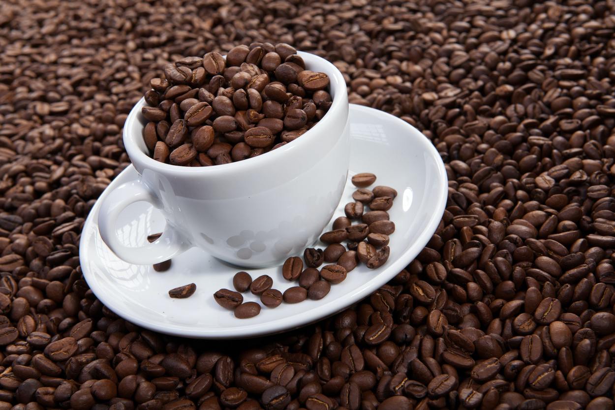 Coffee beans in a cup and saucer 