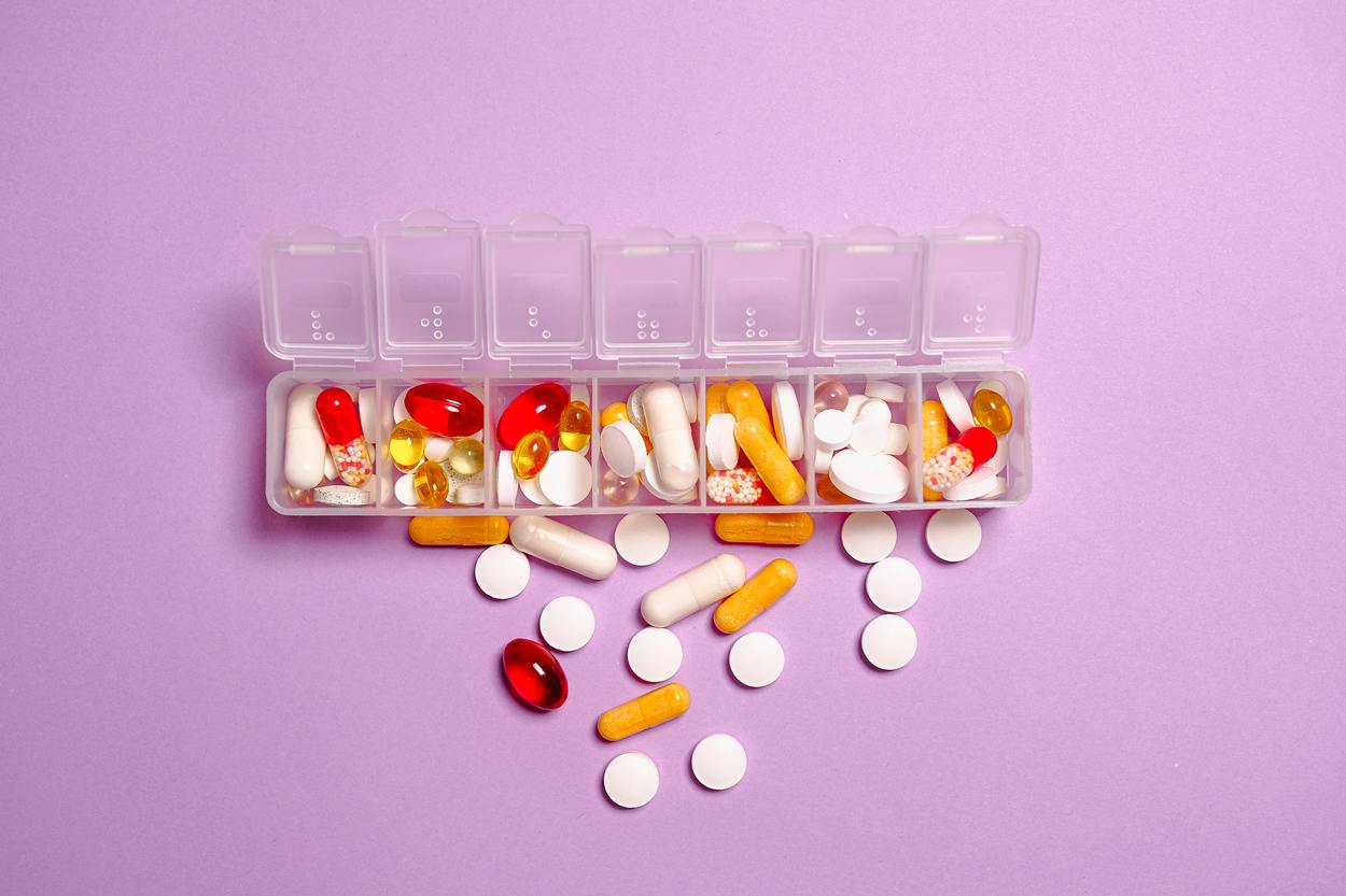 An image of vitamin supplements in the form of tablets and capsules.