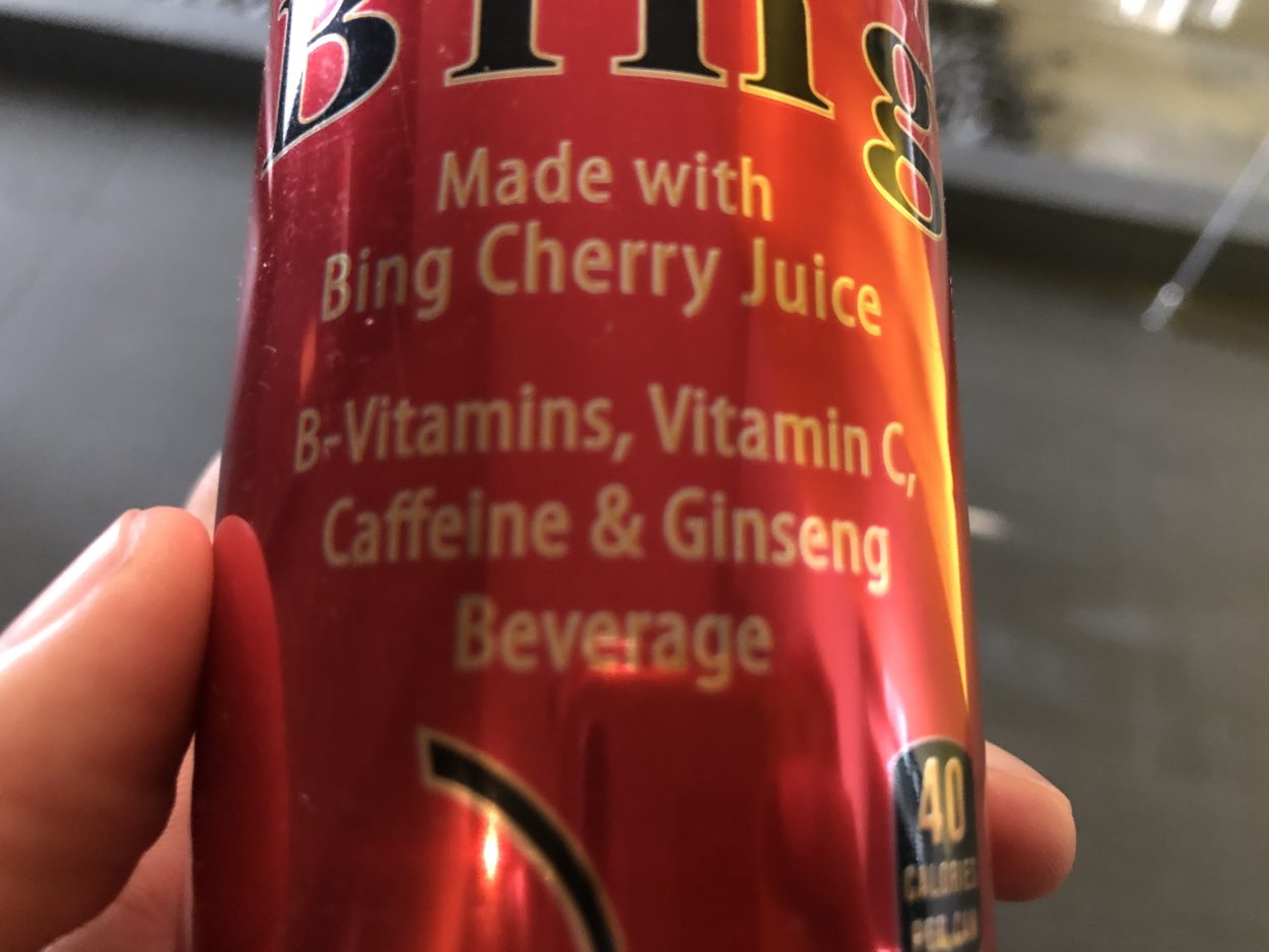 A can of Bing energy drink with "Made with Bing Cherry Juice B-Vitamins, Vitamin C, Caffeine & Ginseng Beverage" written on it.
