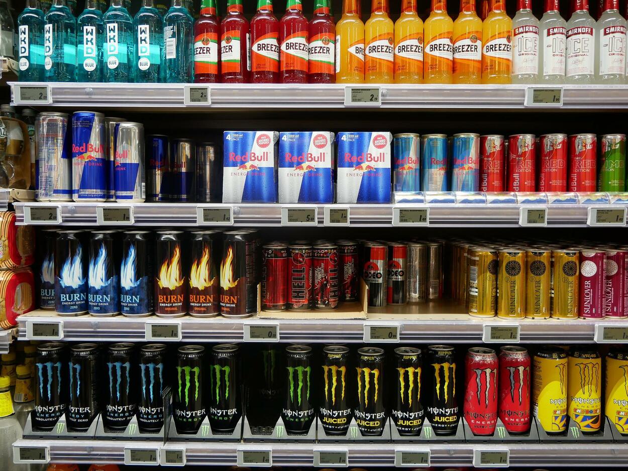 A shelf is full of energy drinks.