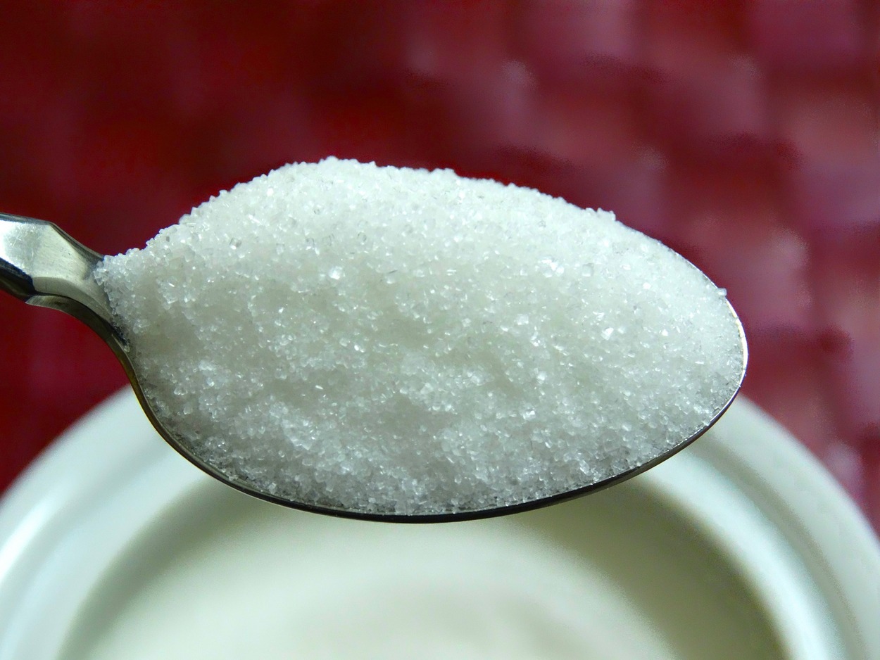 Image of sugar in spoon.