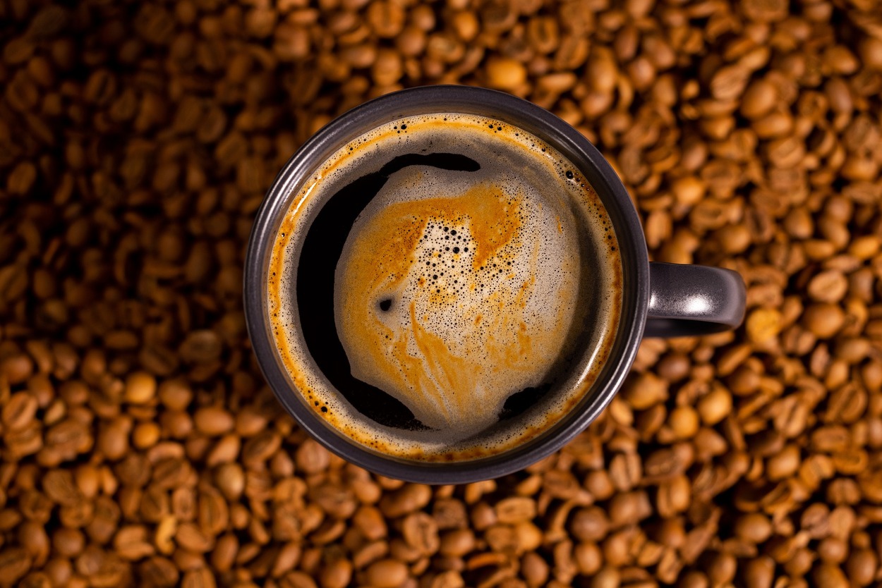 Image of a cup of coffee and coffee beans.